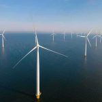Billion-Dollar Buyouts Gut Offshore Wind Offshore wind turbines in rows over calm sea