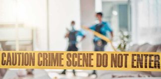 Roommate Arrested After Chilling Find crime scene tape in a living room with two officers in background