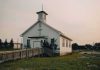 Church Turned Kill Zone — Dozens Vanish Small white church with steeple and cross at sunset