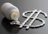 White pills forming a dollar sign beside a spilled pill bottle