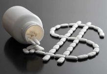 The Fight Over Your Prescription Costs Just Got POLITICAL White pills forming a dollar sign beside a spilled pill bottle