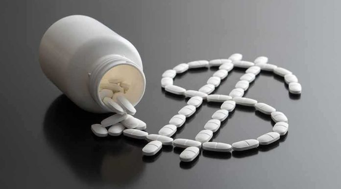 White pills forming a dollar sign beside a spilled pill bottle