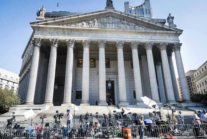 2445868619-2 Reporters and photographers gathered outside a neoclassical courthouse