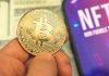 SEC’s Surprising Crypto Door Cracks Open Person holding Bitcoin coin, NFT text on screen.