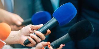 FAA Bombshell Hits LaGuardia Tower Reporters holding colorful microphones