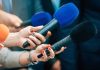 See What Trump Said About the Clancy Case Reporters holding colorful microphones