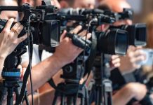 FBI Taps Air Marshals—See Why This Particular Flight television cameras on tripods at a media event