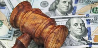 Dems GRILL Bessent Over Trump’s $5,000 Dividend Wooden judge's gavel on scattered US dollar bills