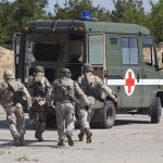 Pentagon Reveals 750+ Americans Wounded in Iran War Soldiers running towards a medical vehicle during a military operation
