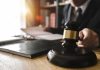 Shocking Conviction Over Kid’s Short Walk Judge's gavel on desk with person reading documents in background