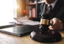 Shocking Conviction Over Kid’s Short Walk Judge's gavel on desk with person reading documents in background