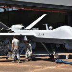 Iran Drones Slaughter Six U.S. Troops Military drone being serviced by ground crew outside a hangar