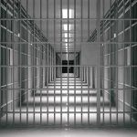 Judge Slams Alabama’s Gas Chamber empty prison corridor with barred cells