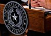 Talarico Bragged About a Favorite Drag Queen Texas governor seal on wooden podium