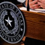 Talarico Bragged About a Favorite Drag Queen Texas governor seal on wooden podium