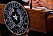 Talarico Bragged About a Favorite Drag Queen Texas governor seal on wooden podium