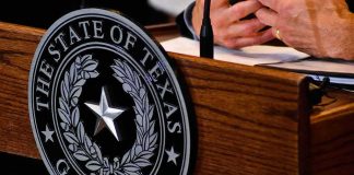Talarico Bragged About a Favorite Drag Queen Texas governor seal on wooden podium