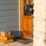 Online Obsession Turns Deadly At The Door Packages stacked on a doorstep by a wooden front door