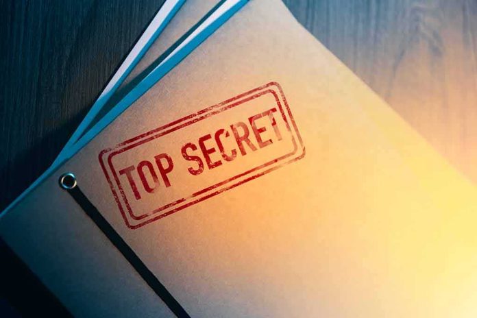 shutterstock_1189065697 Manila folder stamped top secret on a desk