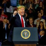 Strong Jobs Report Creates a BIG Problem for Trump Donald Trump speaking at a rally behind a presidential podium