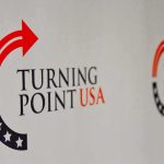 $2 Million Ultimatum Allegedly Hit TPUSA Turning Point USA logo on a backdrop
