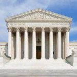 Supreme Court GUTS Damages For Faith Violations Front view of the Supreme Court building with large columns and steps under a blue sky