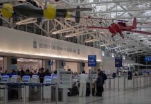 Duct-Taped Airline Passenger FIRED After Viral Meltdown airport security checkpoint with passengers and hanging vintage airplanes