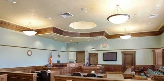 Foster Mom Accused of Trading Teen for MONKEY Avoids Prison Empty courtroom with wooden benches and judge's bench