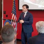 Reddit Rage Puts Dem Candidate On The Ropes Speaker in a navy suit addressing an audience at a podium