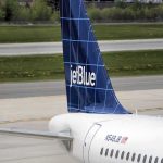 Drone Scare Slams JFK Approach jetBlue airplane tail on airport tarmac