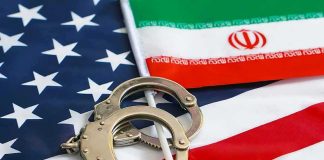 See Inside Iran’s 300% Inflation Handcuffs on U.S. flag beside Iranian flag