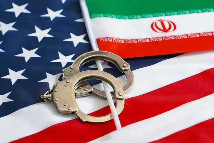 shutterstock_1395090980 Handcuffs on U.S. flag beside Iranian flag