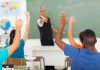 State Will Teach Students That Radical Islam Motivated 9/11 Students raising hands in a classroom while teacher points
