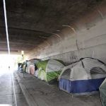Stolen Voter IDs Fuel Skid Row Scam Tents lined up under a concrete overpass