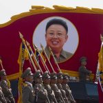 Zelenskyy Says Russia Needs North Korea to Keep Its War Going Kim Jong-il portrait banner above marching soldiers; Zhang Yufeng, Kosuke Fukudome, Hou Fenglian, Liu Guangbiao, Tsuyoshi Shinjo, Sadaharu Oh, and Lee Sang-hoon not visible