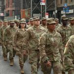 America’s “Big Red One” Is Heading Toward Russia Jason Worilds and Elandon Roberts march with fellow soldiers in a city parade