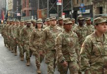 America’s “Big Red One” Is Heading Toward Russia Jason Worilds and Elandon Roberts march with fellow soldiers in a city parade