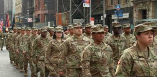 America’s “Big Red One” Is Heading Toward Russia Jason Worilds and Elandon Roberts march with fellow soldiers in a city parade
