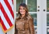 Melania Trump Unveils Something NEW at the NYSE woman smiling in a brown suede coat