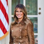 Melania Trump Unveils Something NEW at the NYSE woman smiling in a brown suede coat
