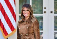 Melania Trump Unveils Something NEW at the NYSE woman smiling in a brown suede coat
