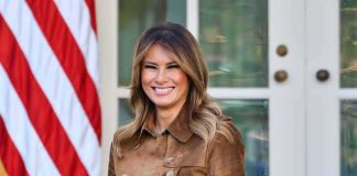 woman smiling in a brown suede coat