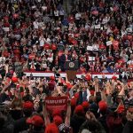 Trump Just Changed The Midterm Playbook Speaker at podium addressing large crowd in arena