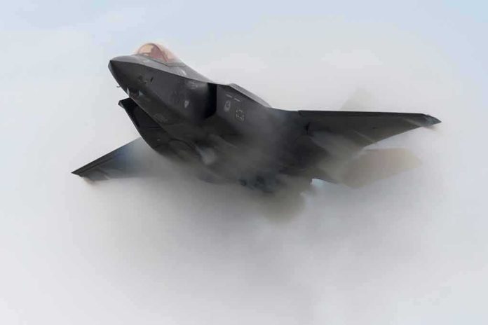 shutterstock_1638650581 Stealth fighter jet piercing a vapor cloud
