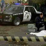 2 Ole Miss Students Found DEAD in Separate Incidents Crime scene with police car and two investigators by a covered body