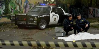 2 Ole Miss Students Found DEAD in Separate Incidents Crime scene with police car and two investigators by a covered body