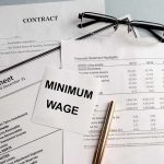 Jobs The $25 Wage Plan Could WIPE OUT First Minimum wage note on financial documents with glasses and pen
