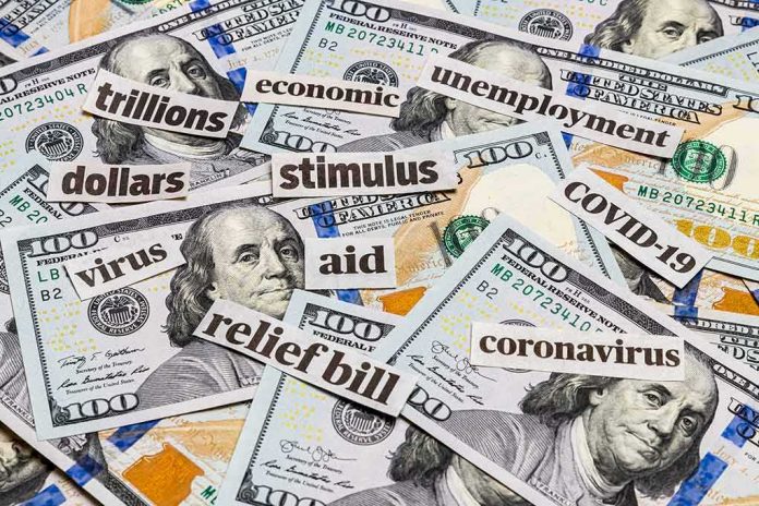 shutterstock_1718623261 Hundred-dollar bills with cutout words about stimulus and economy