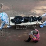 Families Claim Loved Ones After Deadly Thailand School Shooting health workers in PPE move a body on a stretcher