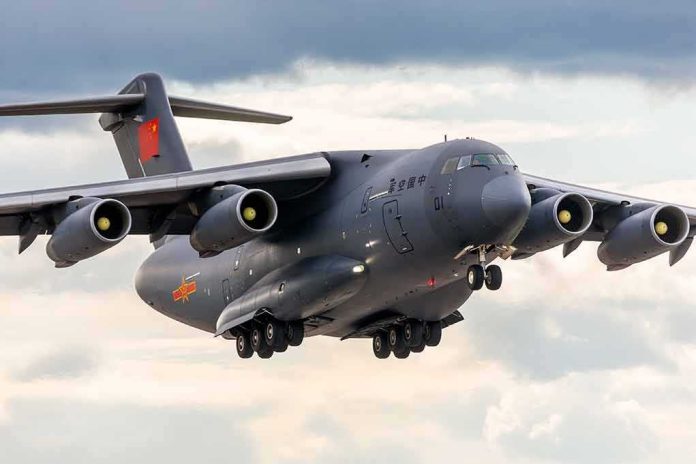 Military transport aircraft with four engines landing